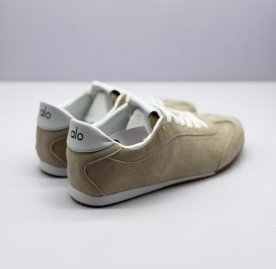 Rear three-quarter view showing the white heel collars and Alo branding.