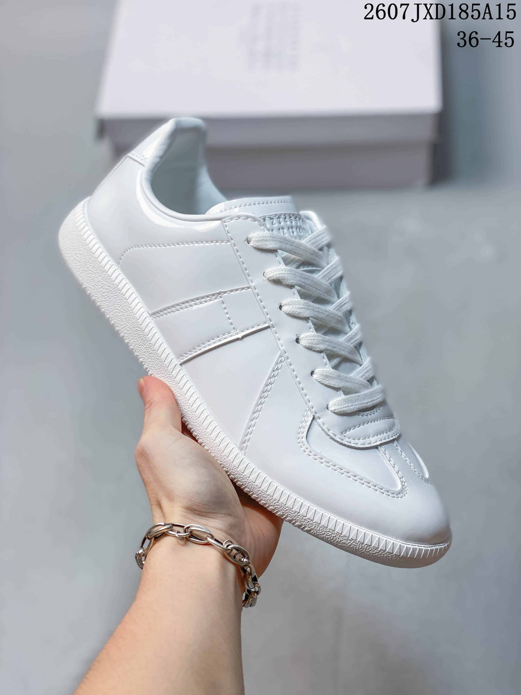 Angled side view of the white sneaker showing the lace-up upper and rubber sole
