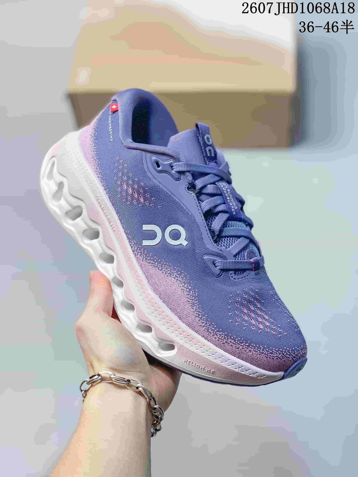Angled side view of the purple and pink sneaker showing the lace system, patterned upper, side branding, and white outsole.