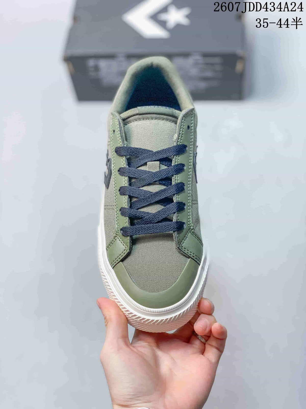 Top view of the sneaker showing the green upper, dark navy laces, rounded toe, and white rubber foxing.
