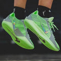 Pair of green and gray Nike basketball shoes with lace-up closures and iridescent side accents