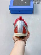 Rear view of the sneaker showing the silver heel panel, red accents, padded collar, and layered outsole.