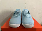 Front view of light blue Nike basketball shoes with matching laces and white toe soles.