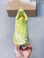 Top view of the lime yellow sneaker showing the mesh-style upper, tongue pull tab, reflective toe accent, and On branding.