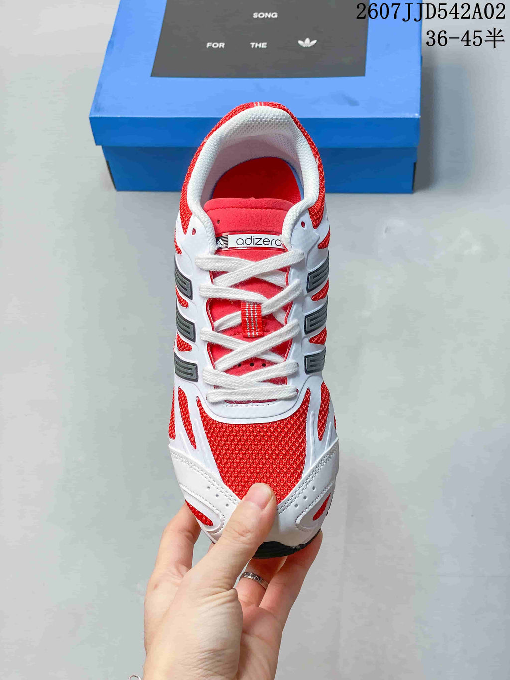 Top view of the adidas Adizero sneaker with white laces and red panels