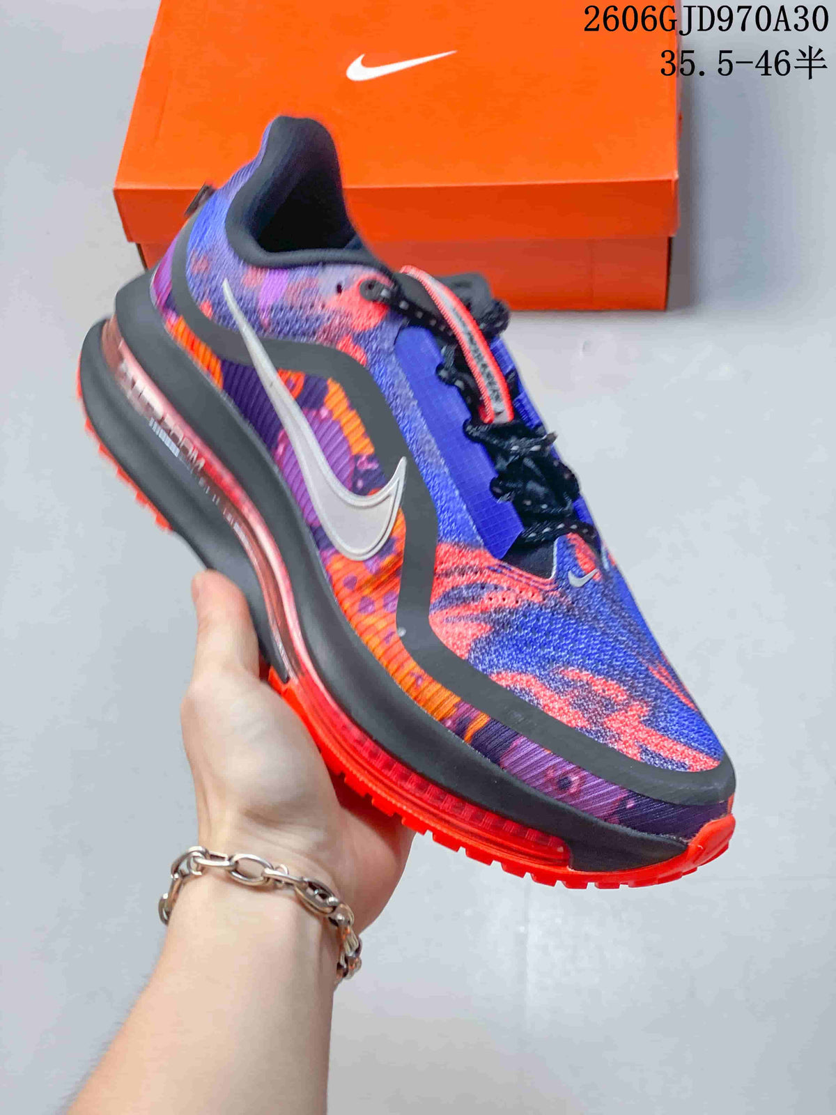 Side view of the blue, purple, and orange running shoe with a contrasting outsole