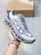 Side view of a white On Cloudtilt Remix sneaker with blue accents and a sculpted sole.