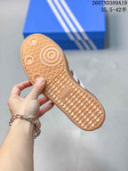 Close-up of the textured gum-colored outsole with circular traction details and adidas branding.