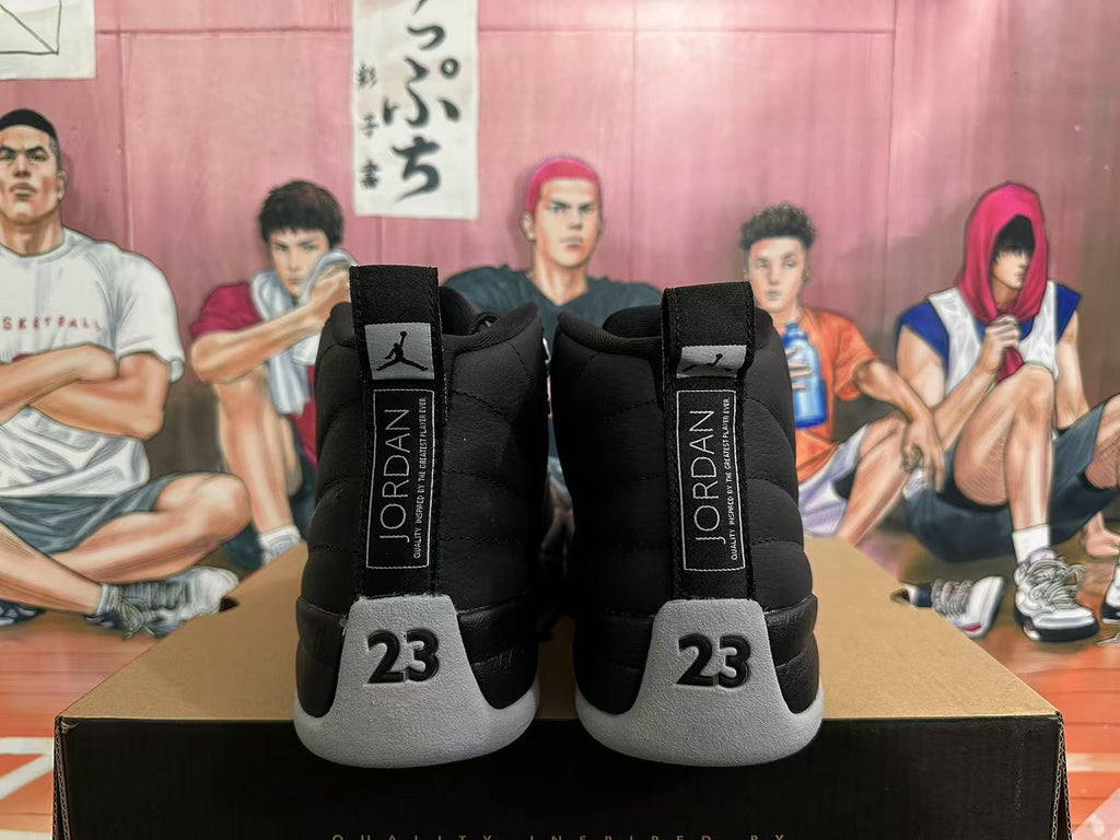 Rear view of black and grey Jordan 12 high-top sneakers