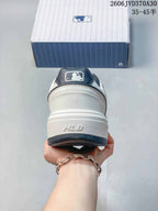 Rear view of the sneaker with a raised MLB mark on the heel and navy trim.