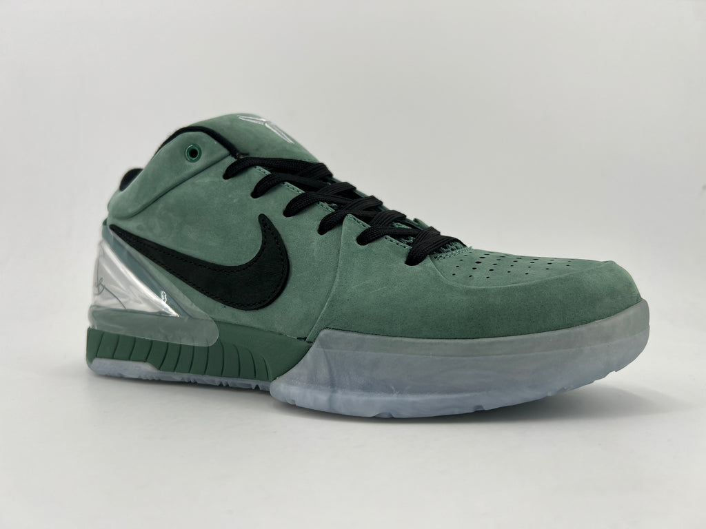 Angled view of the green Nike Kobe basketball shoe with black laces and clear heel accent