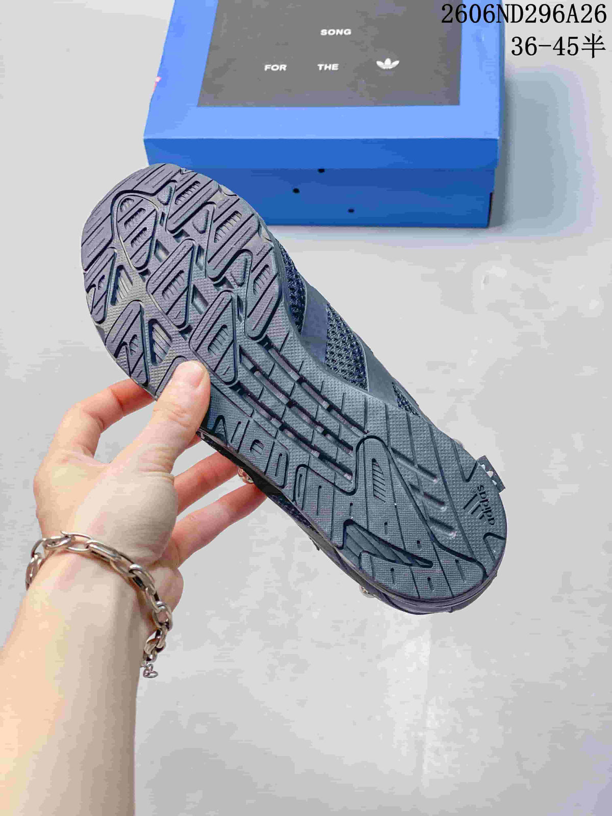 Close view of the patterned rubber outsole on a black and gray sneaker.