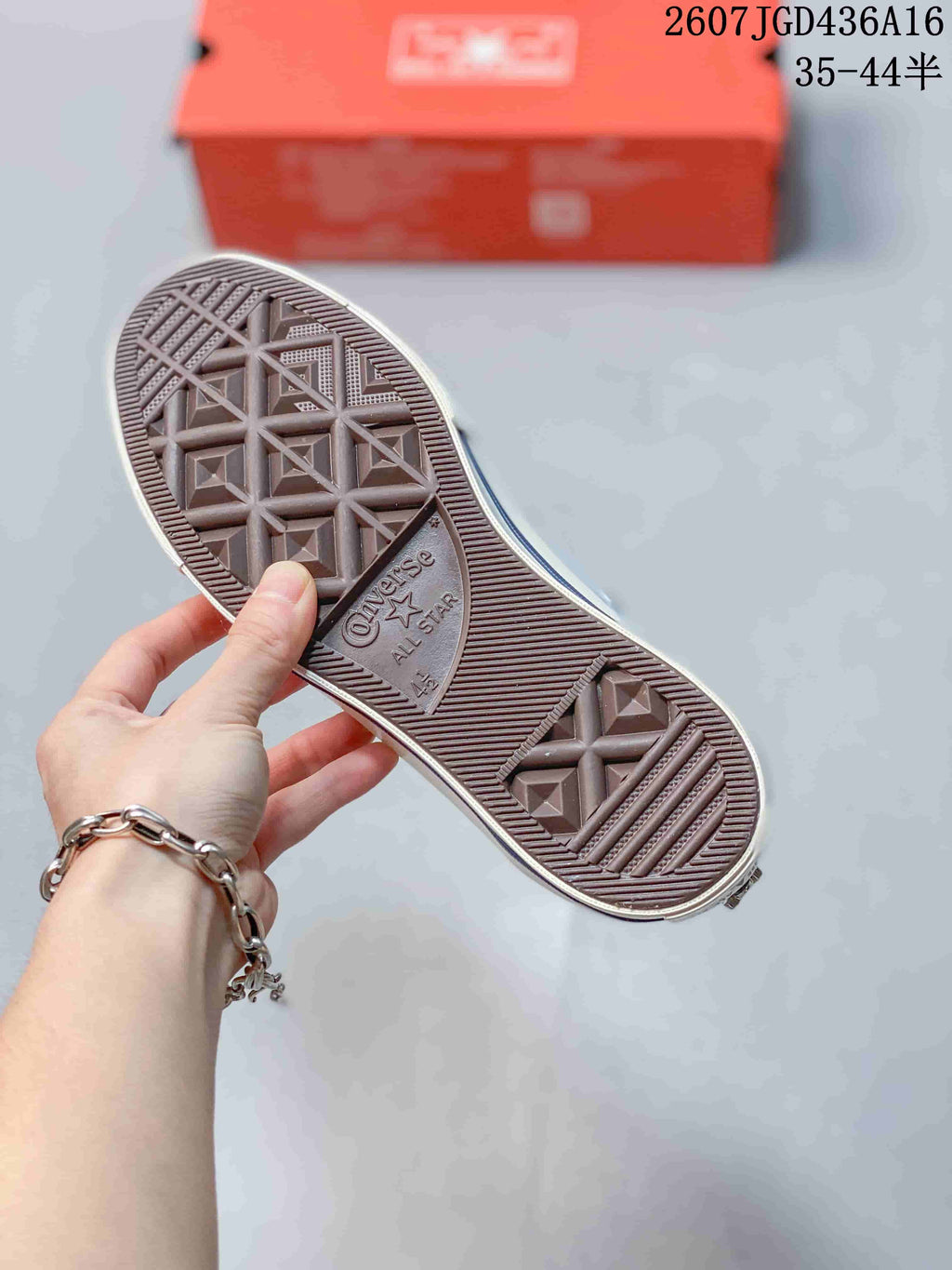 Close view of the brown textured outsole with Converse All Star branding and geometric traction patterns.