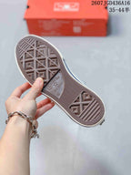 Close view of the brown textured outsole with Converse All Star branding and geometric traction patterns.