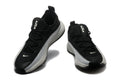 Pair of black and white low-top Nike LeBron training shoes shown from the front and side.