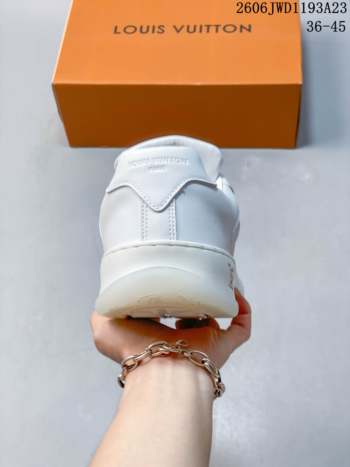 Rear view of a white sneaker with branded heel details