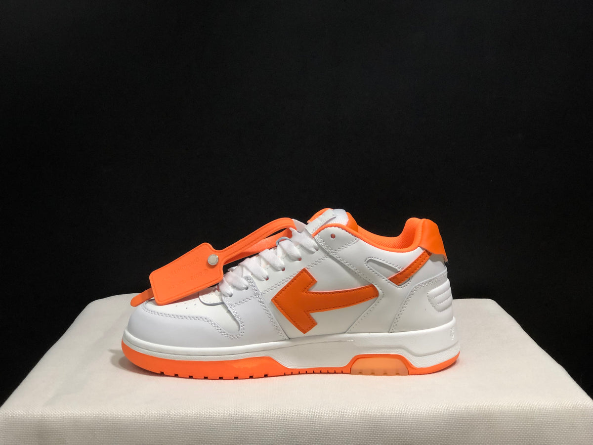 Full side profile showing the low-top silhouette, orange side arrow, white upper, and layered sole.