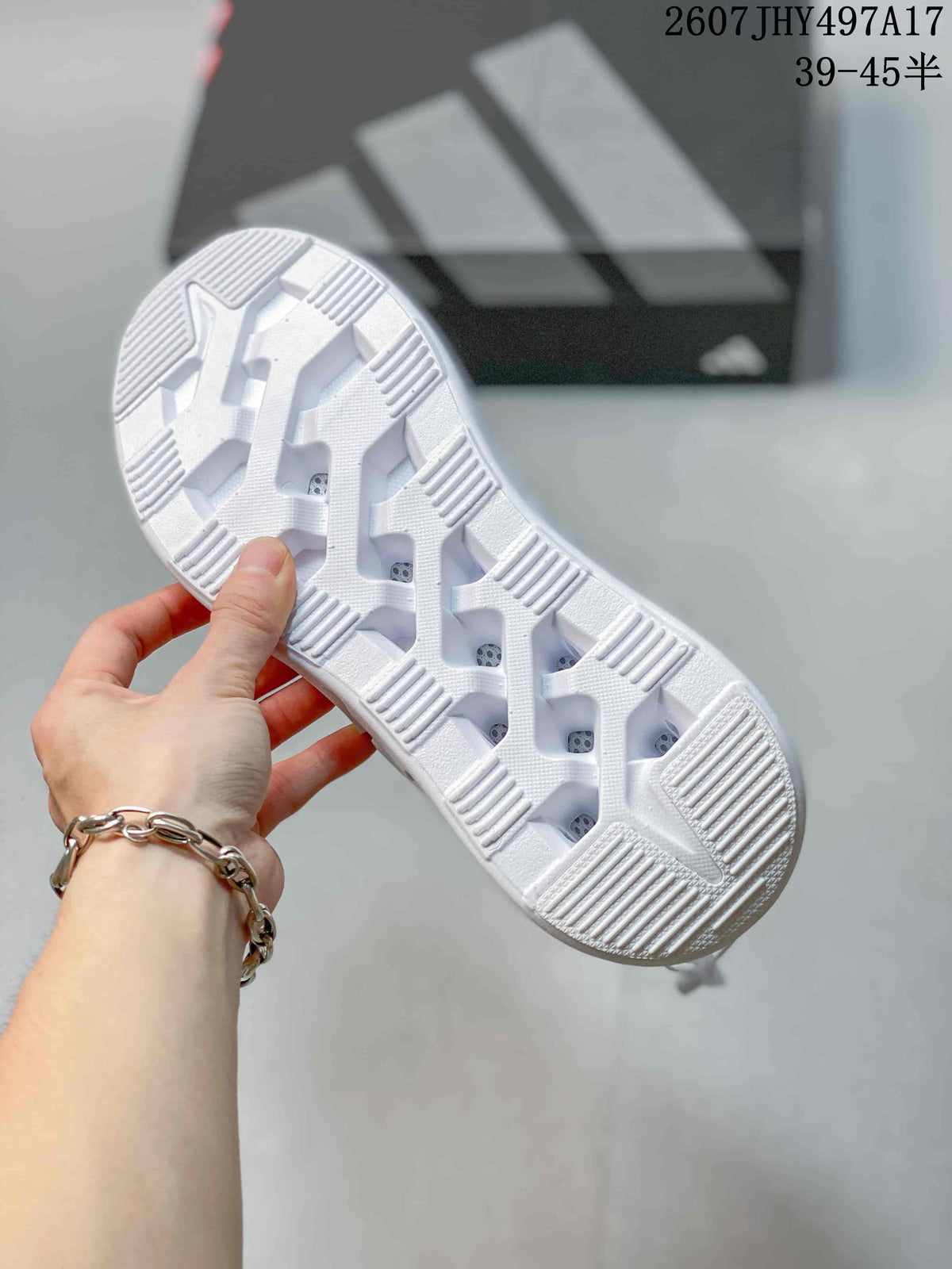 Underside view showing the white outsole with segmented traction blocks and textured grip zones.