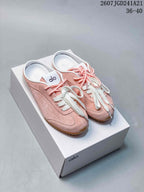 Pair of pink Alo sneakers with white laces displayed on a white box.