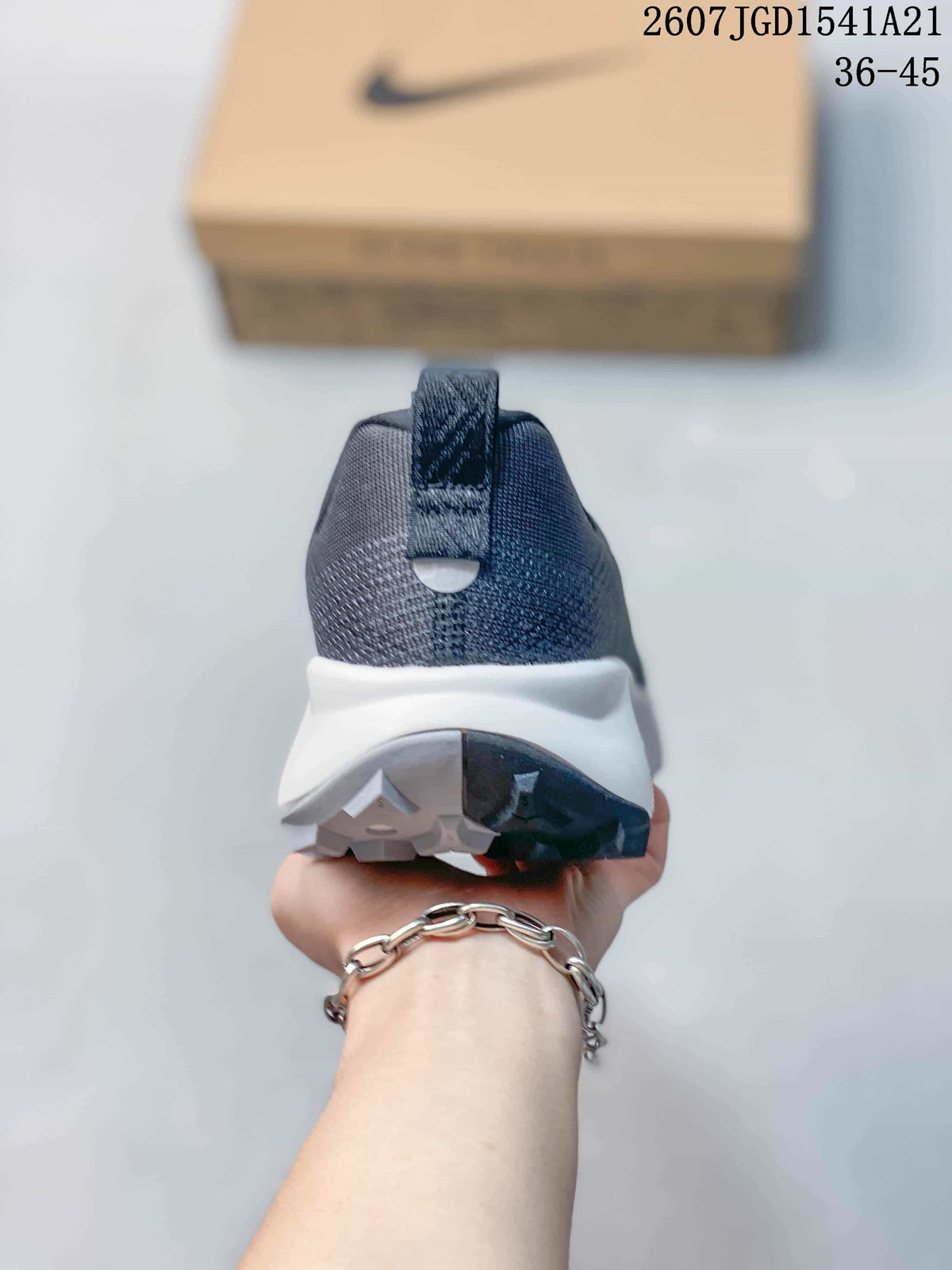 Rear view of the sneaker showing the padded heel collar, heel pull tab, white midsole, and split-color outsole.