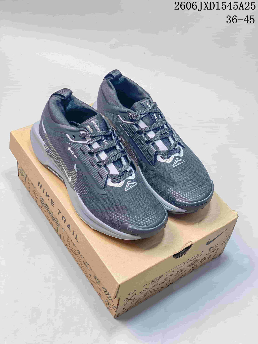 Pair of dark gray Nike Pegasus Trail 5 GORE-TEX trail running shoes on a box