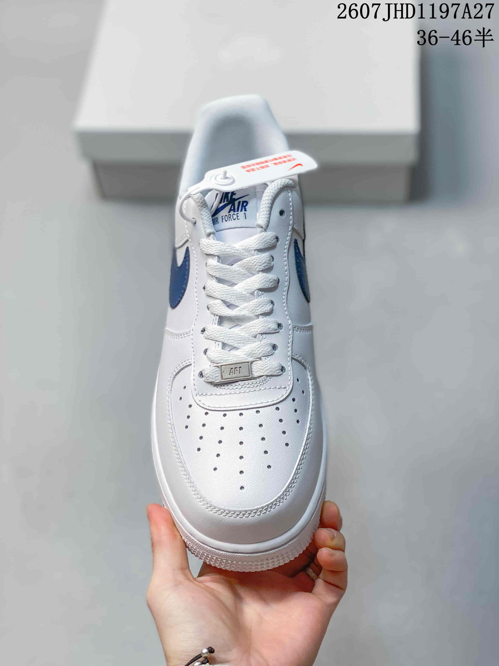Top view showing white laces, perforated toe box, blue tongue label and metallic lace ornament.