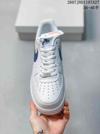 Top view showing white laces, perforated toe box, blue tongue label and metallic lace ornament.