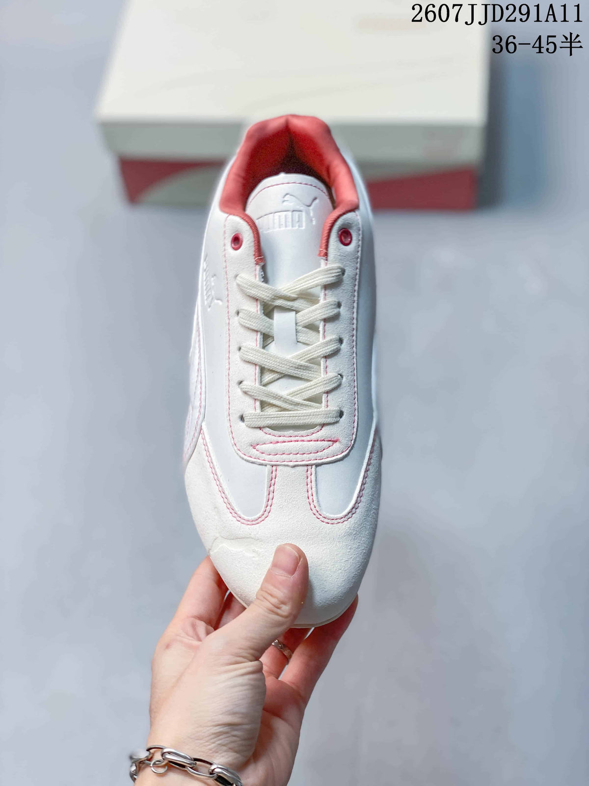 Top view showing the lace-up design, rounded toe, white upper, and pink-red collar lining.