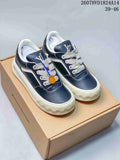 Pair of navy and white Louis Vuitton low-top sneakers displayed on a box, with style code and size range visible above.