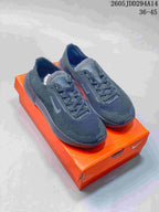 Pair of dark gray Nike Free 2025 sneakers displayed on an orange shoebox, with style code 2605JDD294A14 and size range 36-45 visible.
