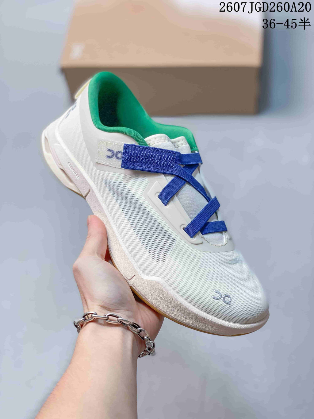 Close side view of a white On Cloudnova Moon sneaker with blue straps and a green padded collar.