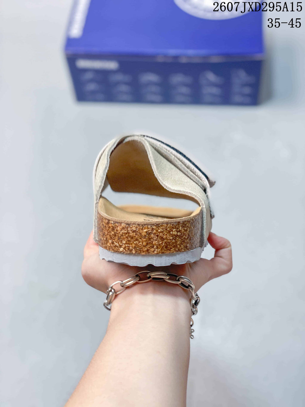 Rear view of the sandal showing the open heel, cork-look midsole, and textured outsole.