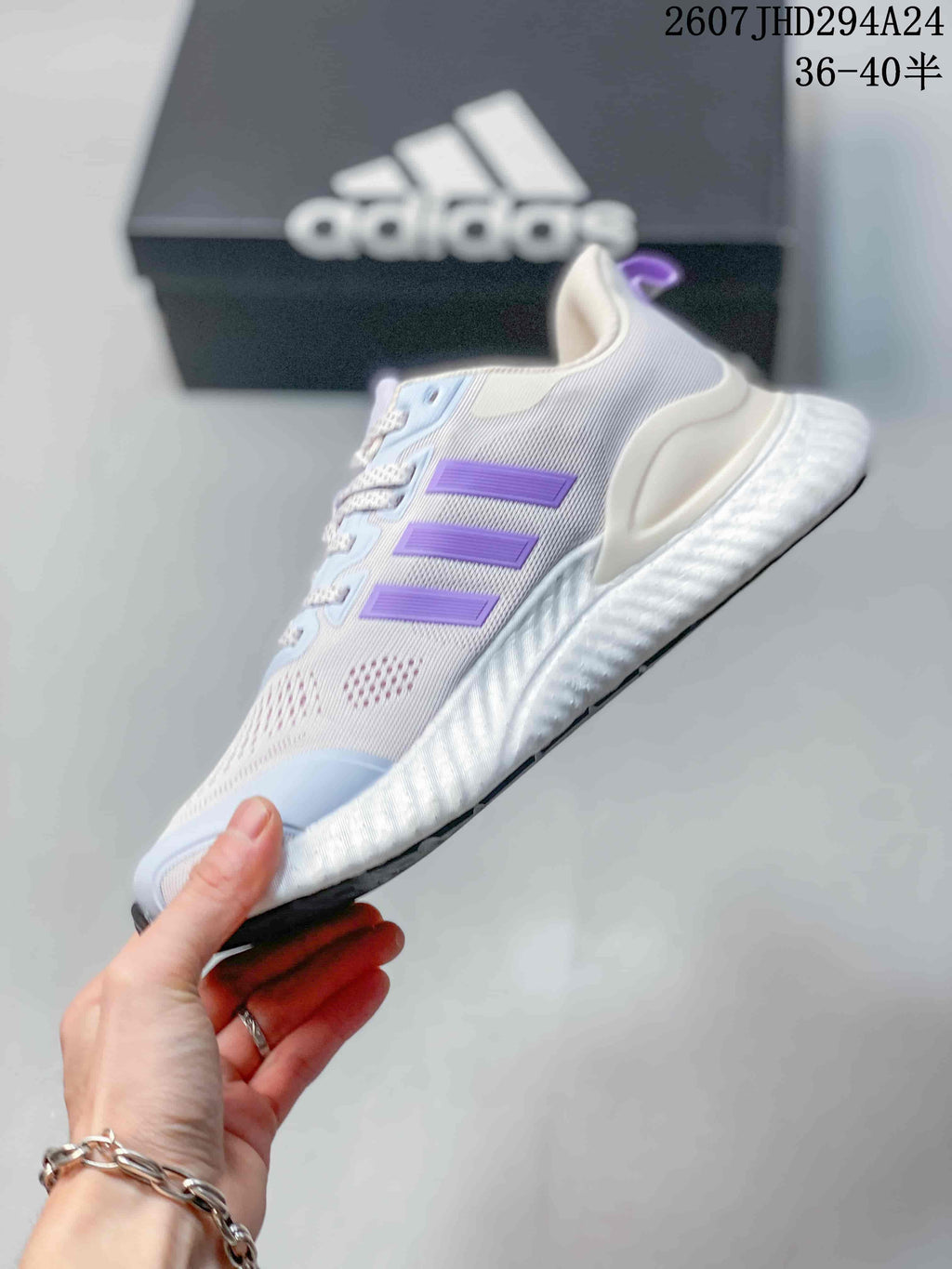 Side view showing the white mesh upper, three lilac stripes, layered overlays, and raised sole.