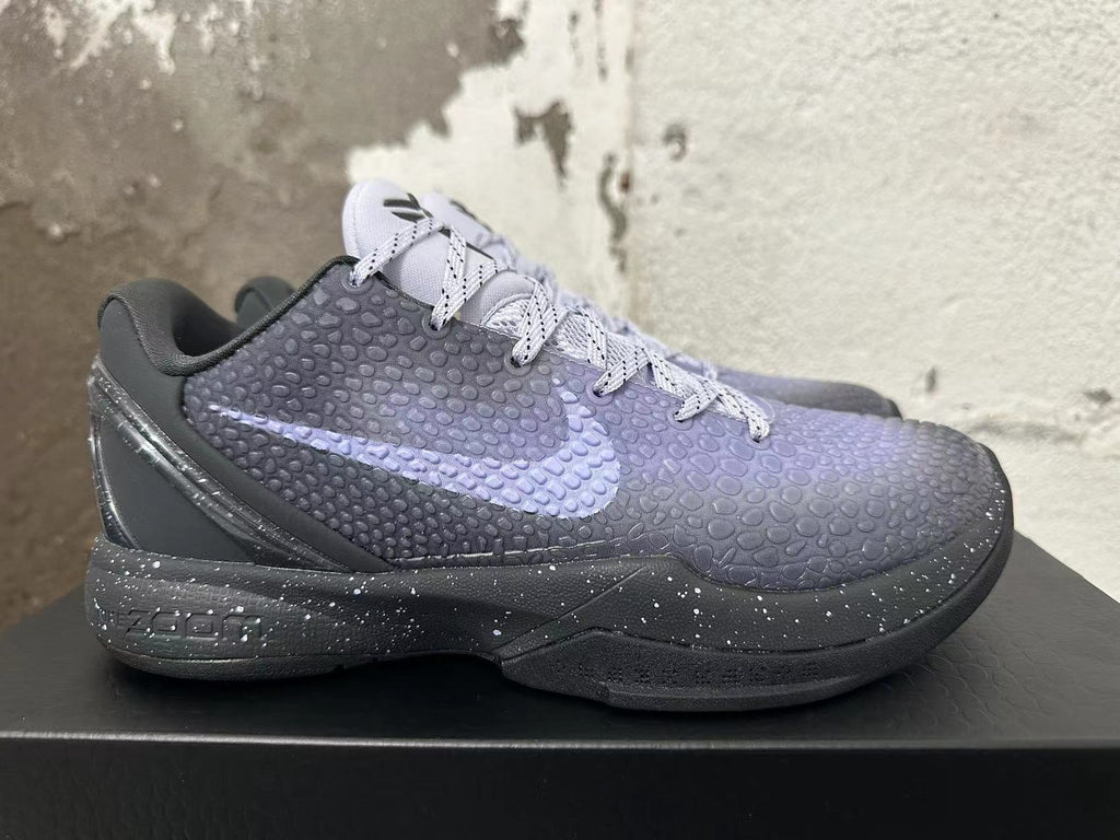 Side view of a Kobe 6 shoe with a textured upper, pale purple Swoosh, and speckled midsole
