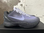 Side view of a Kobe 6 shoe with a textured upper, pale purple Swoosh, and speckled midsole