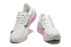 White Nike Zoom Fly 6 shoes with black swooshes and pink accents, viewed from the front