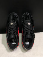 Top view showing black laces, perforated toe panels, padded collars, and BAPE STA branding inside the shoes.