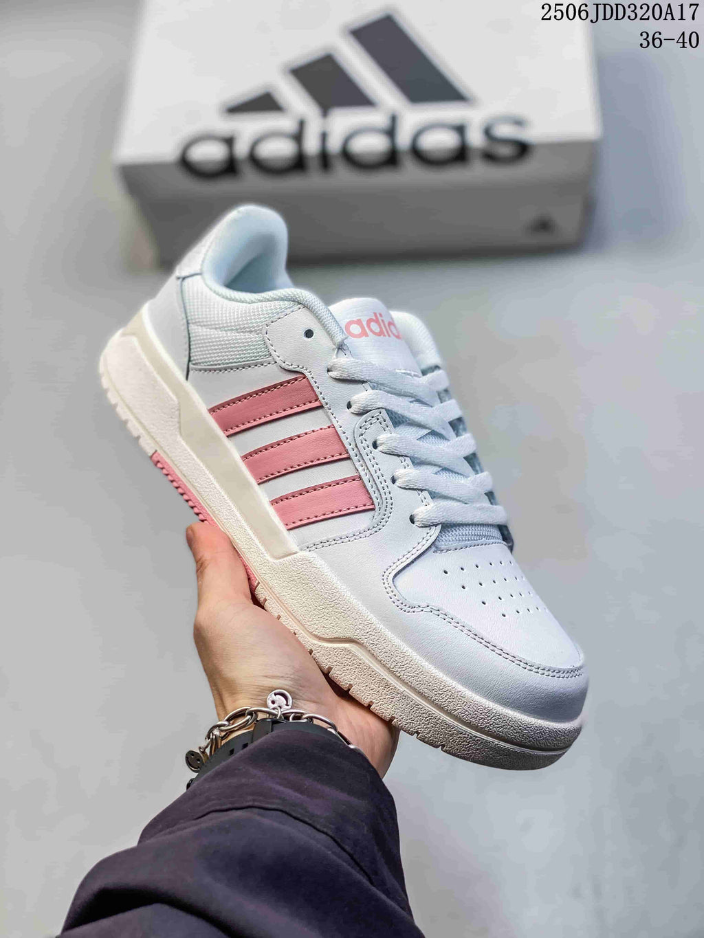 Angled side view of the white and pink adidas Entrap sneaker with its layered upper and textured outsole.