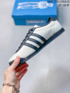 Side profile showing the off-white upper, navy three stripes, and low-profile sole.