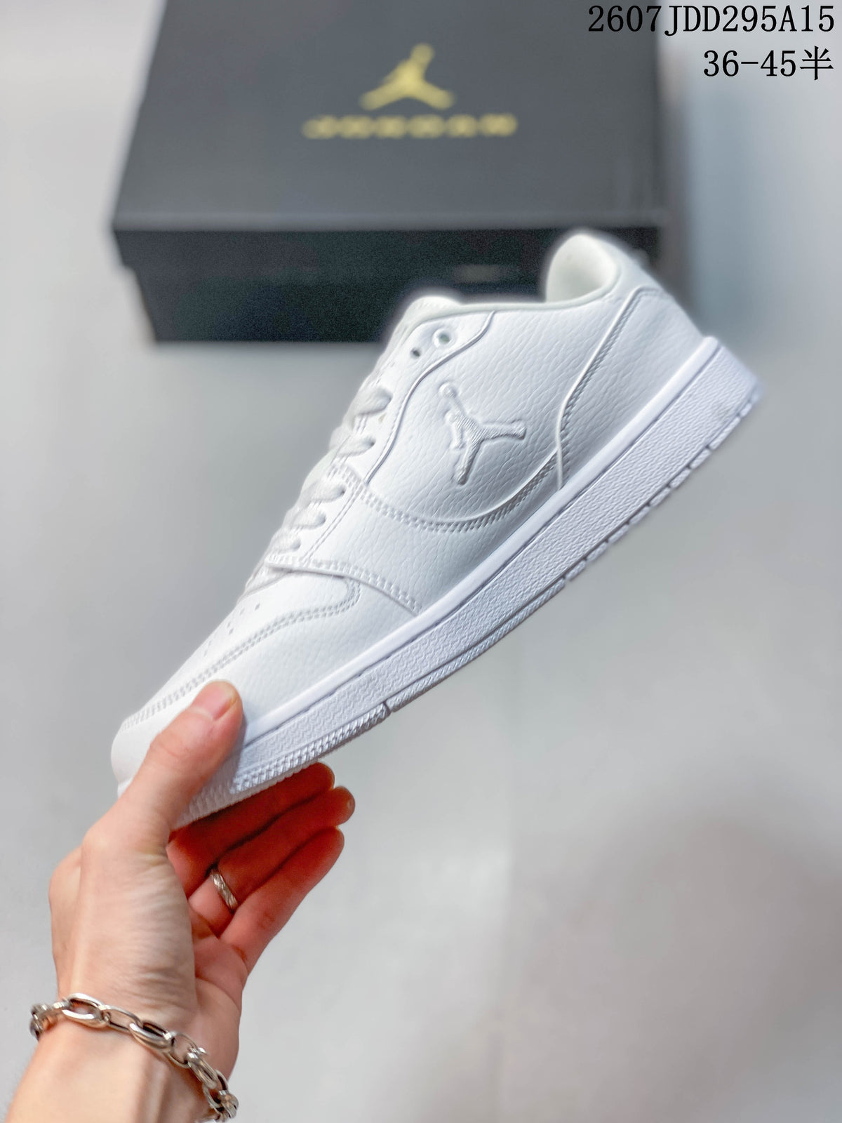 Side profile of the white low-top sneaker showing the Jordan side logo, stitched panels and flat rubber sole.