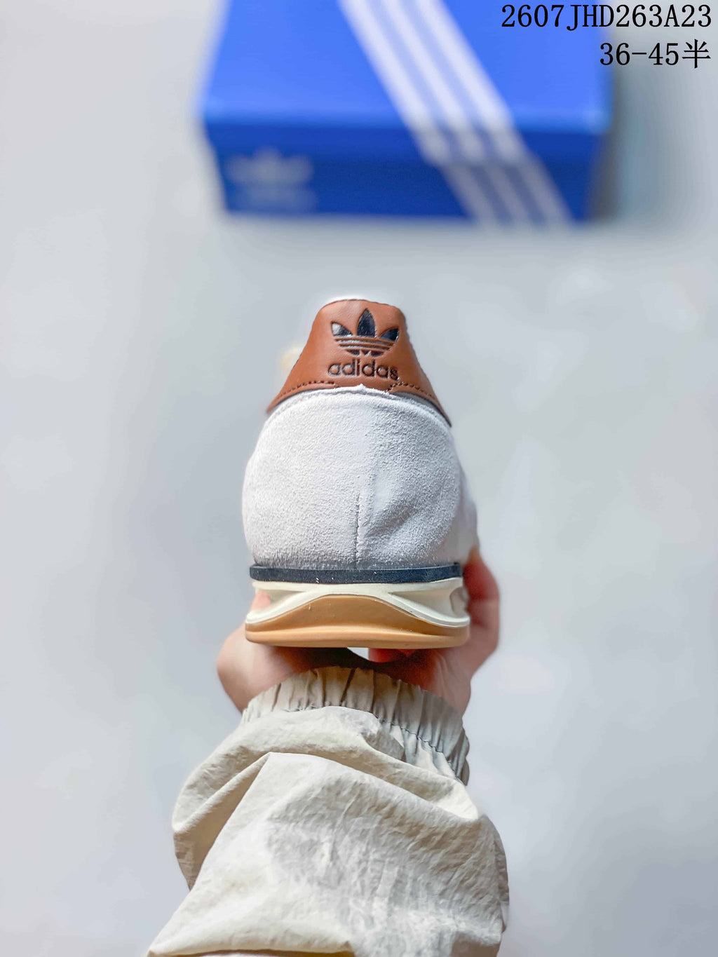 Rear view showing the white heel, brown adidas-branded heel tab and layered outsole.