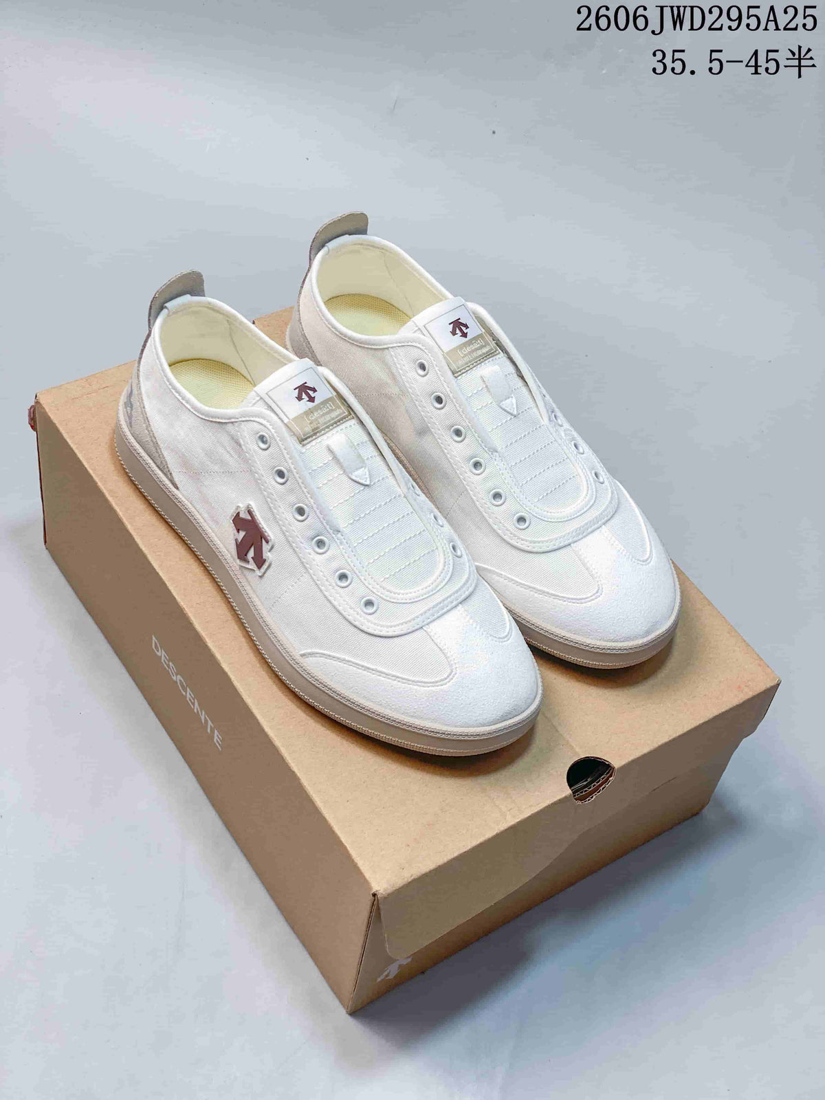 Pair of white and gray DESCENTE sneakers shown from above