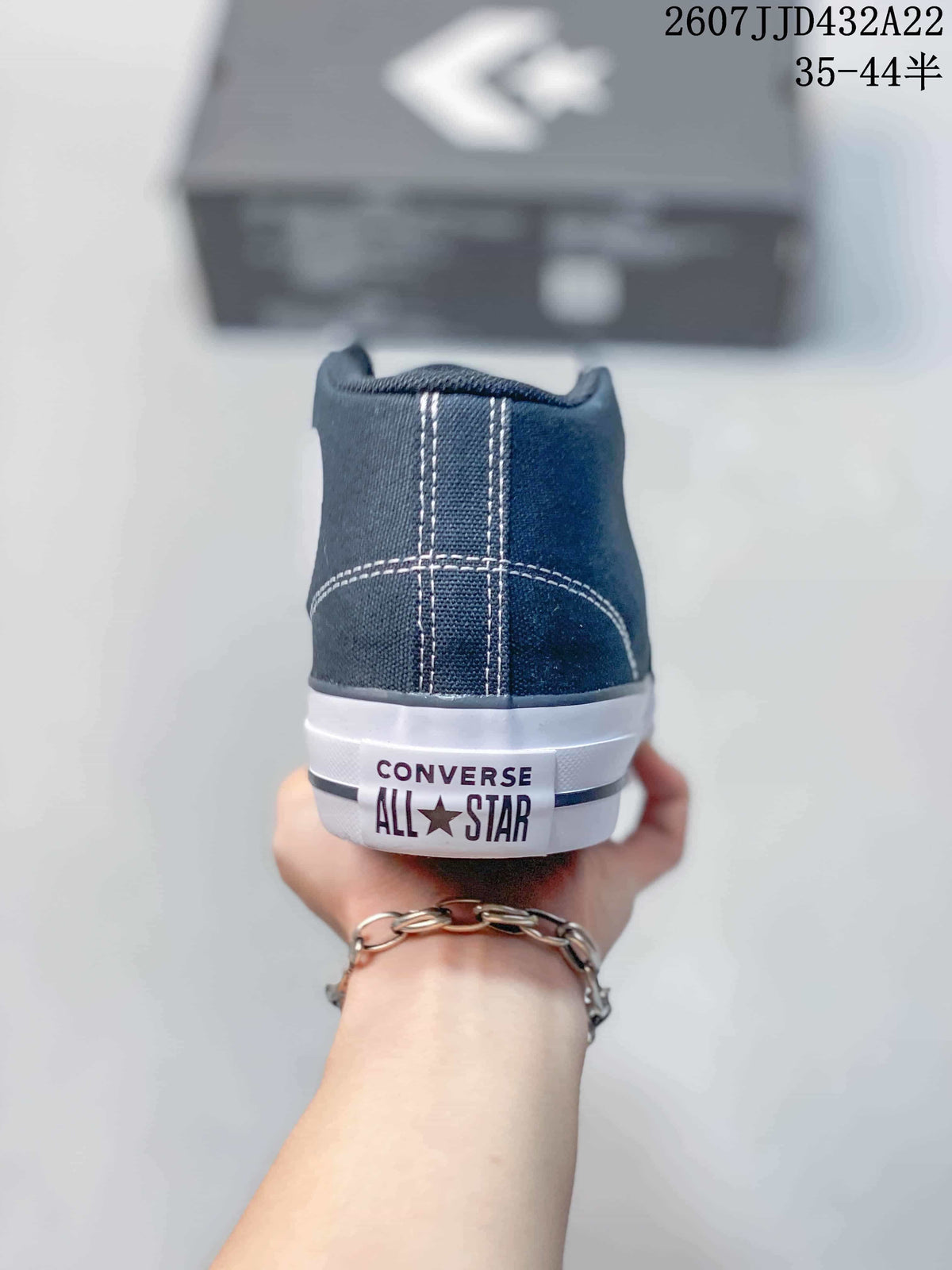 Rear view showing the navy canvas heel, contrast stitching and Converse All Star heel branding.