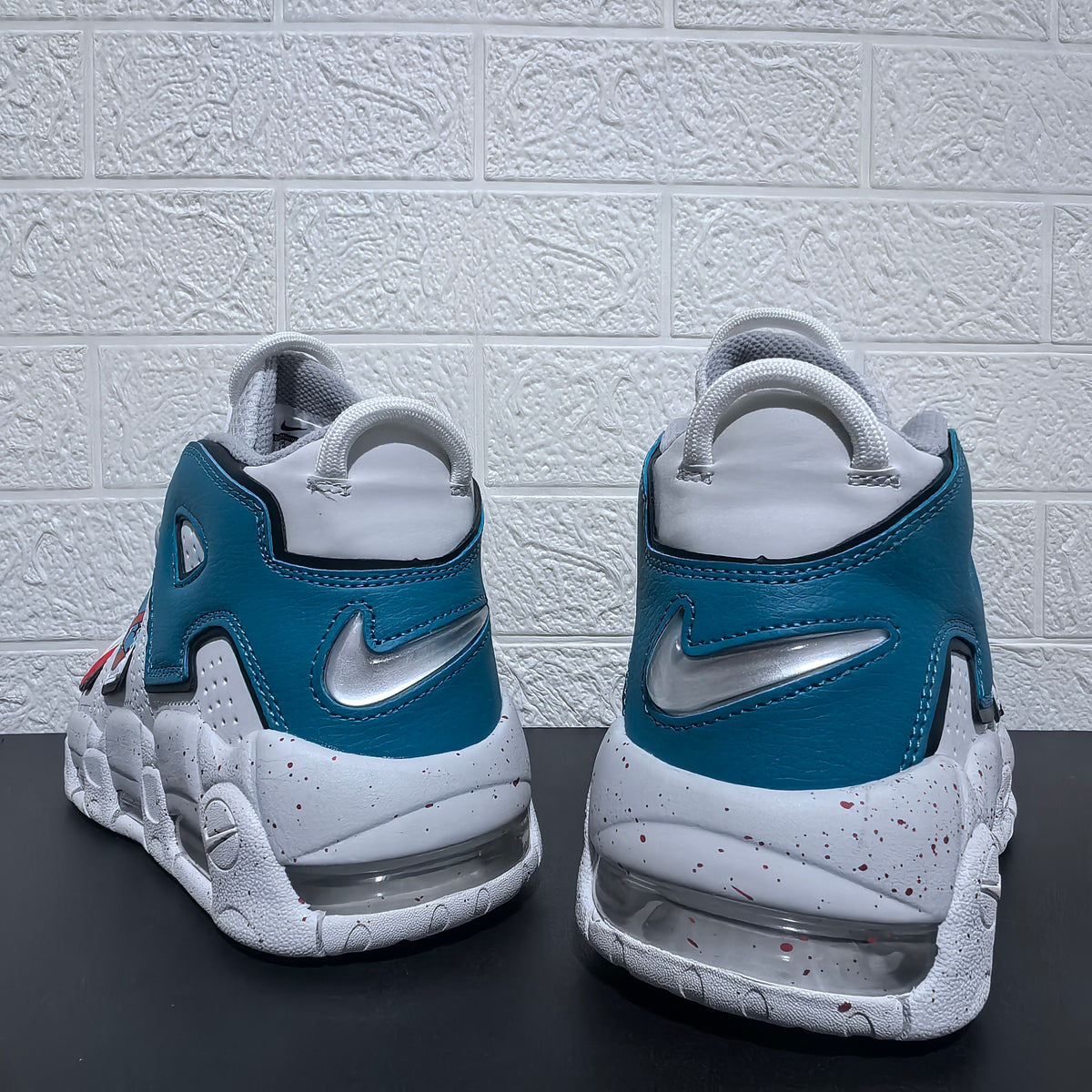 Rear view showing blue heel panels, swoosh details and visible cushioning