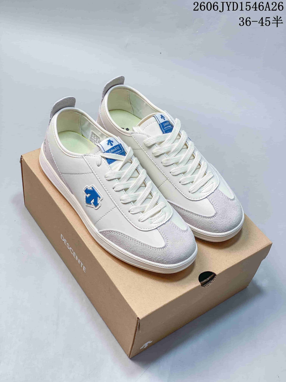 White and gray Descente low-top sneakers with a blue side emblem on a box