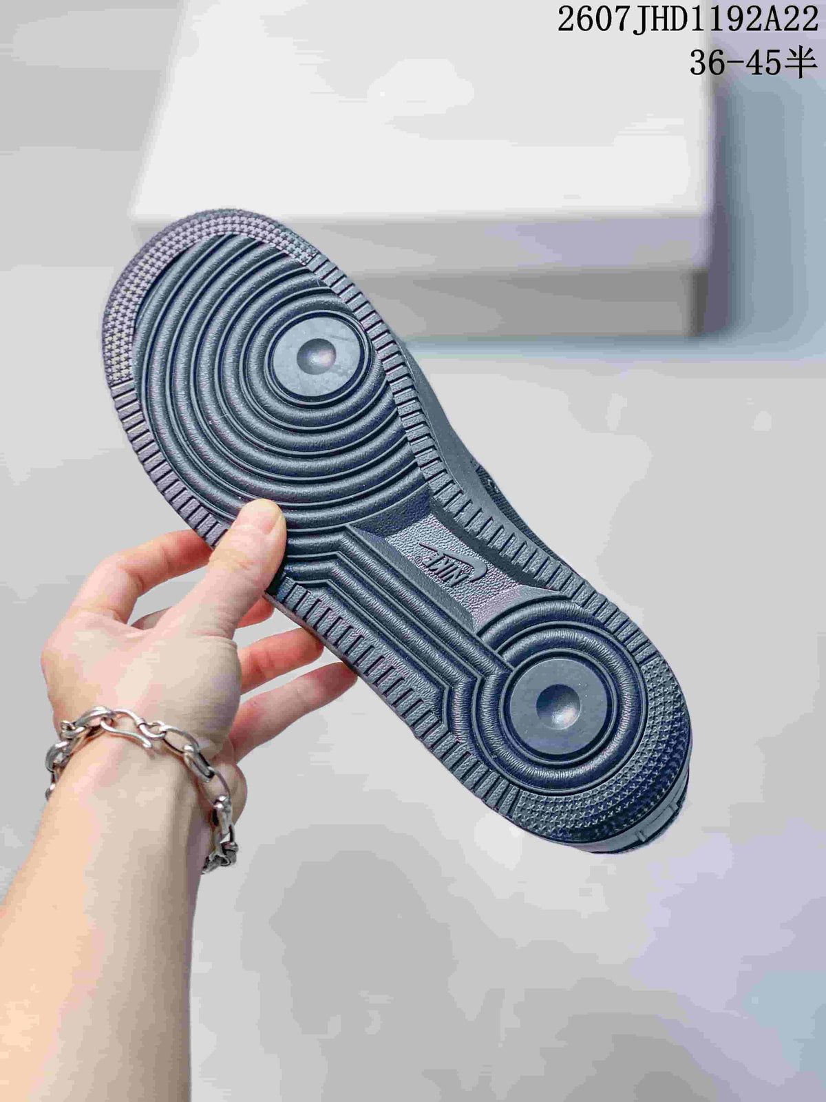 Close-up of the sneaker outsole showing circular traction patterns and textured tread.