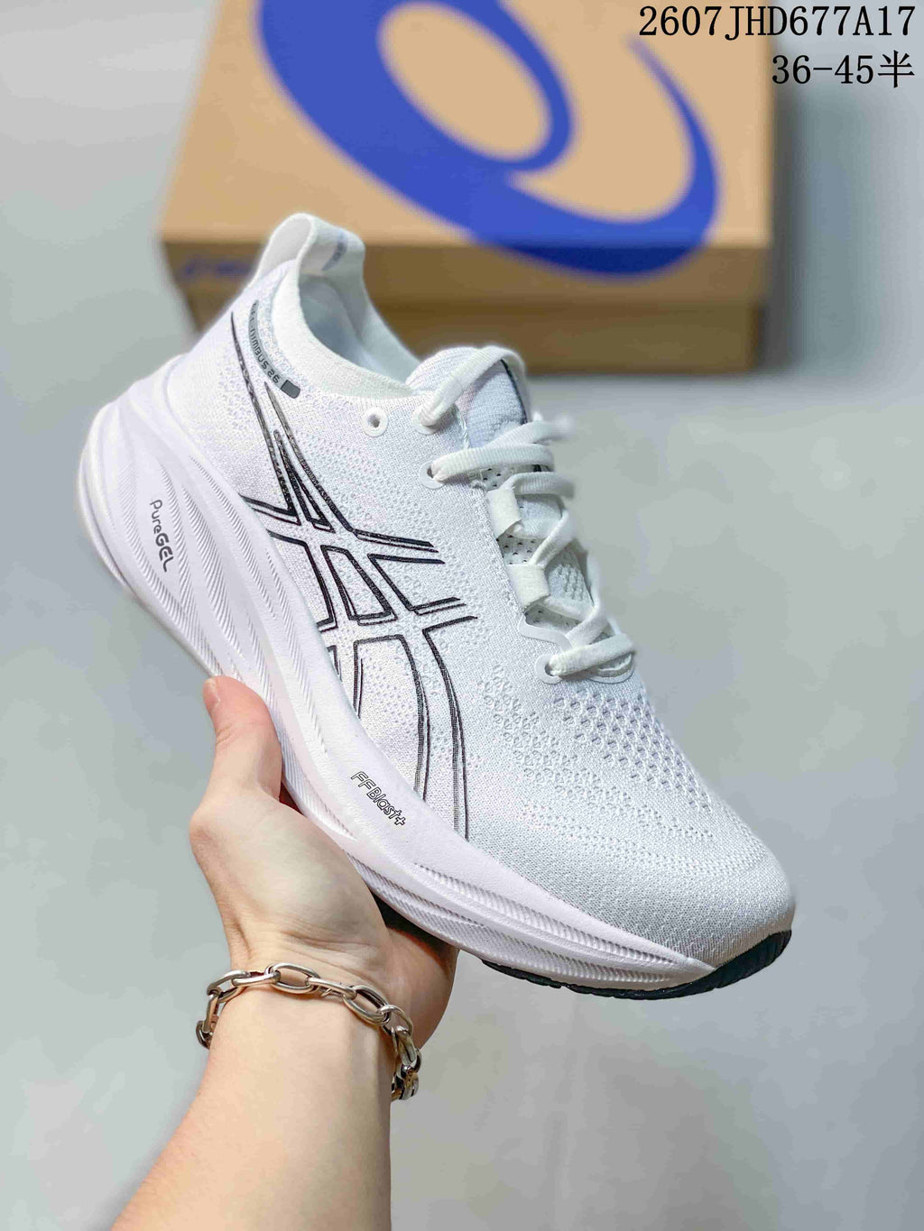 White ASICS Gel-Nimbus 26 sneaker with dark outlined side branding, white laces, and a white sculpted midsole.
