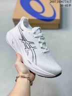 White ASICS Gel-Nimbus 26 sneaker with dark outlined side branding, white laces, and a white sculpted midsole.