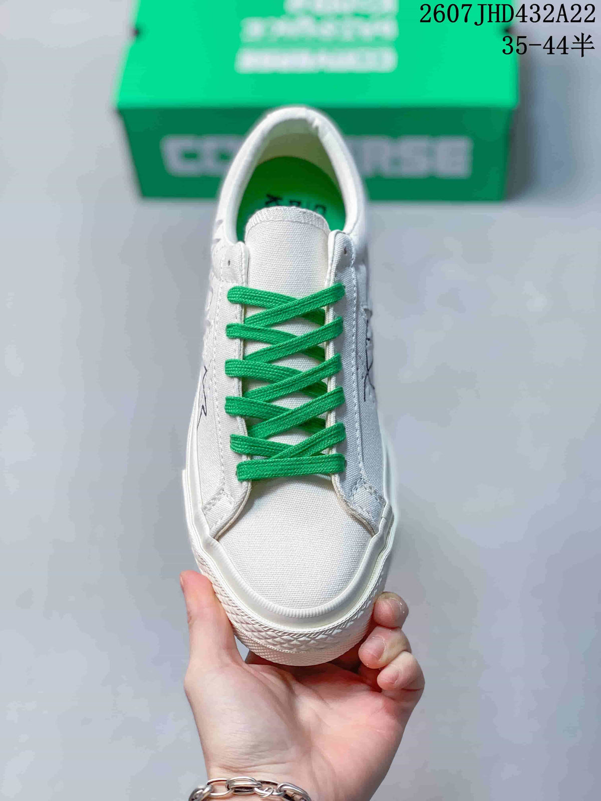Top view of the white sneaker showing the bright green laces and rounded rubber toe.