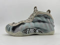 Side view of a grey and black marbled Nike Air Foamposite One high-top sneaker with a patterned midfoot panel.